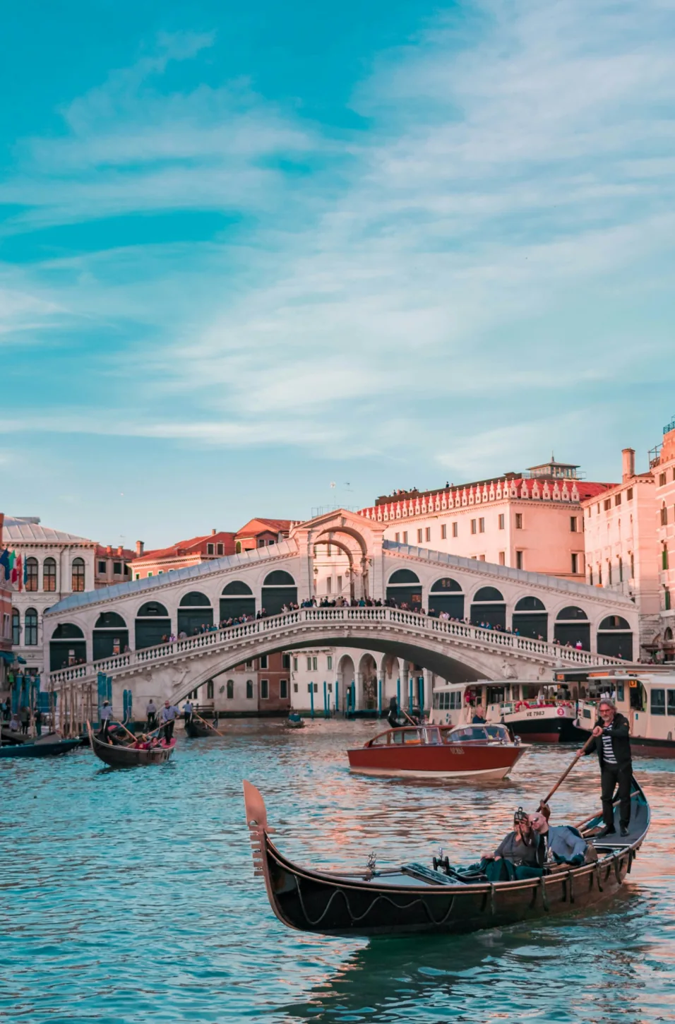 Venice canal with bridge, boats and colourful buildings