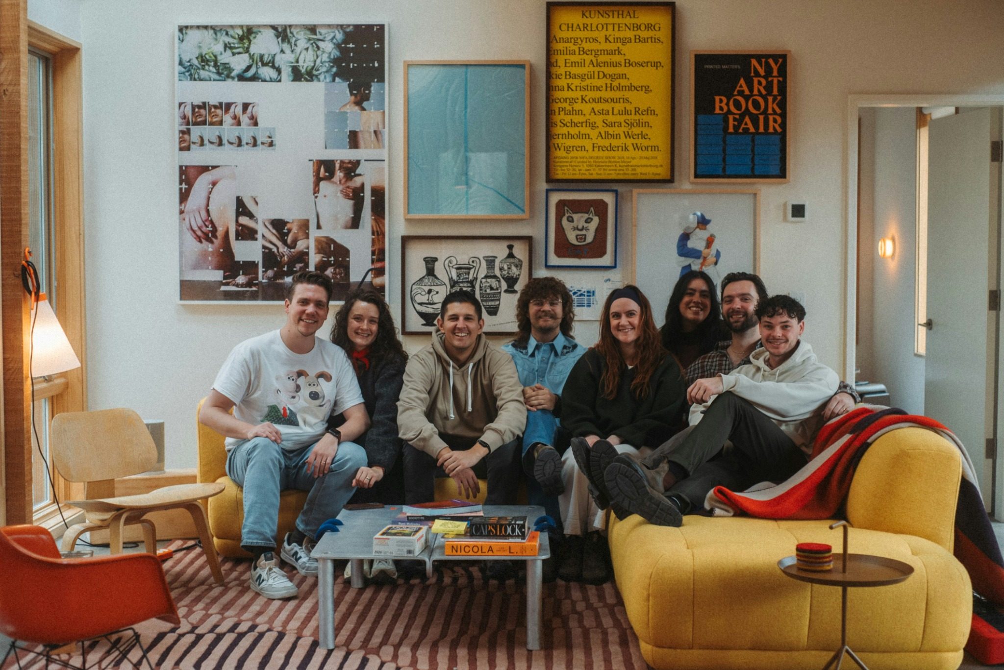 A group of friends sitting together in a colourful living room